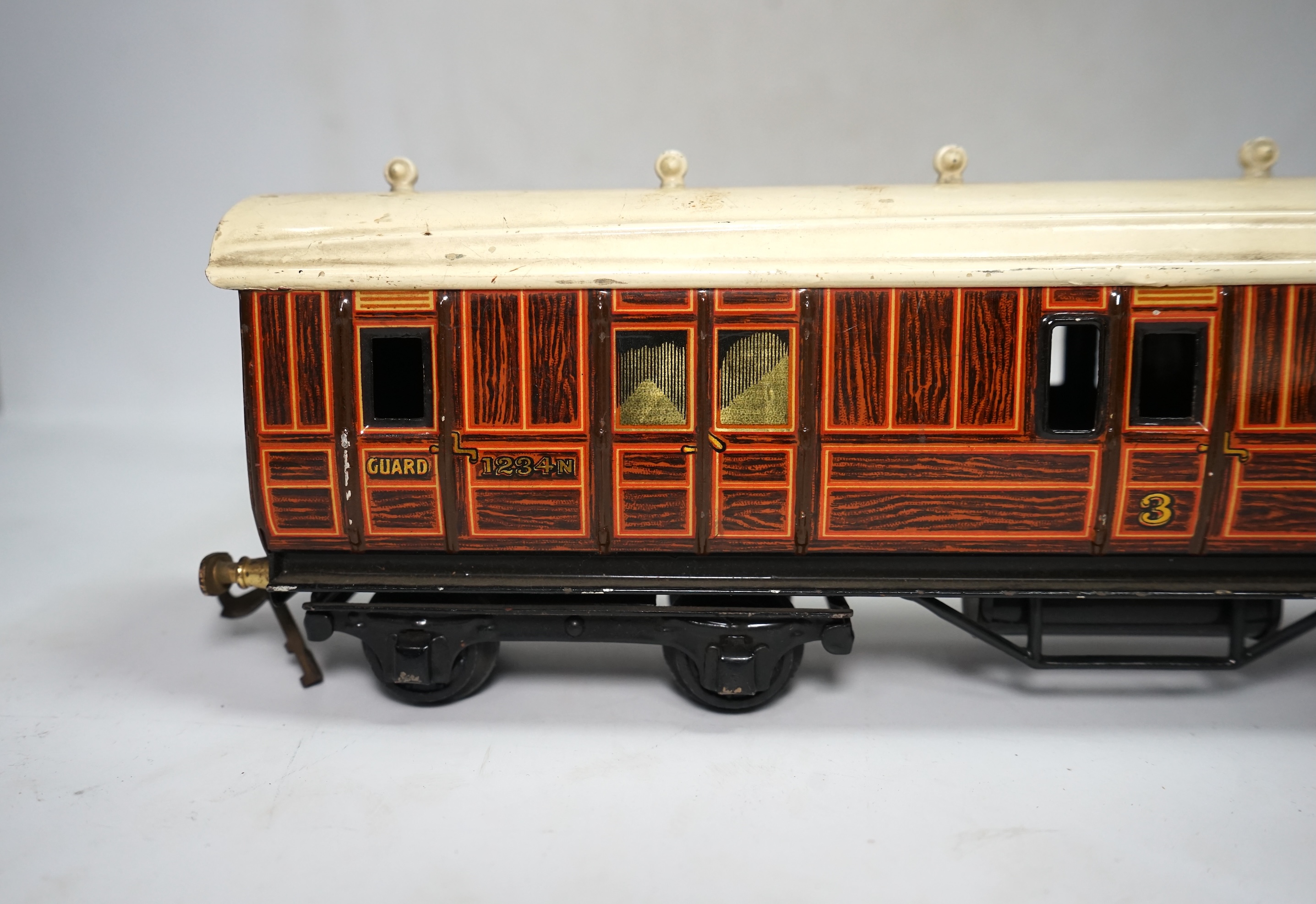 A wooden boxed Bowman Models live steam spirit fired 0 gauge 4-4-0 tender locomotive (without tender), loosely styled in black LNWR livery, together with a tinplate 0 gauge Bing for Bassett Lowke LNER teak bogie coach, 1